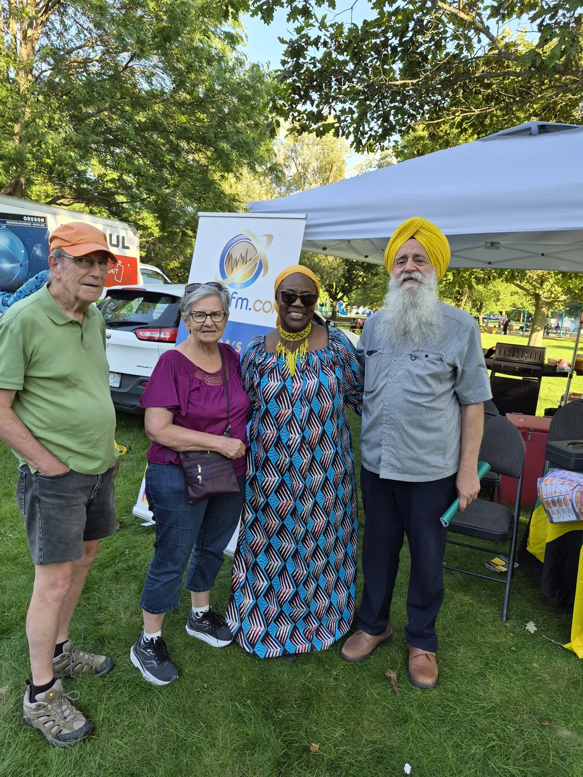 Gurinder Pal Singh meeting neighbours at a community booth during the African-Caribbean Mosaic Cultural Festival